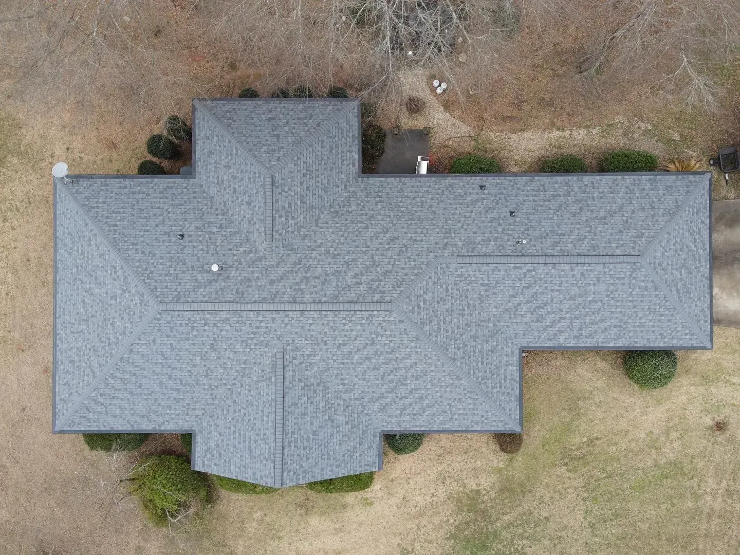 An aerial view of a house with a new roof.