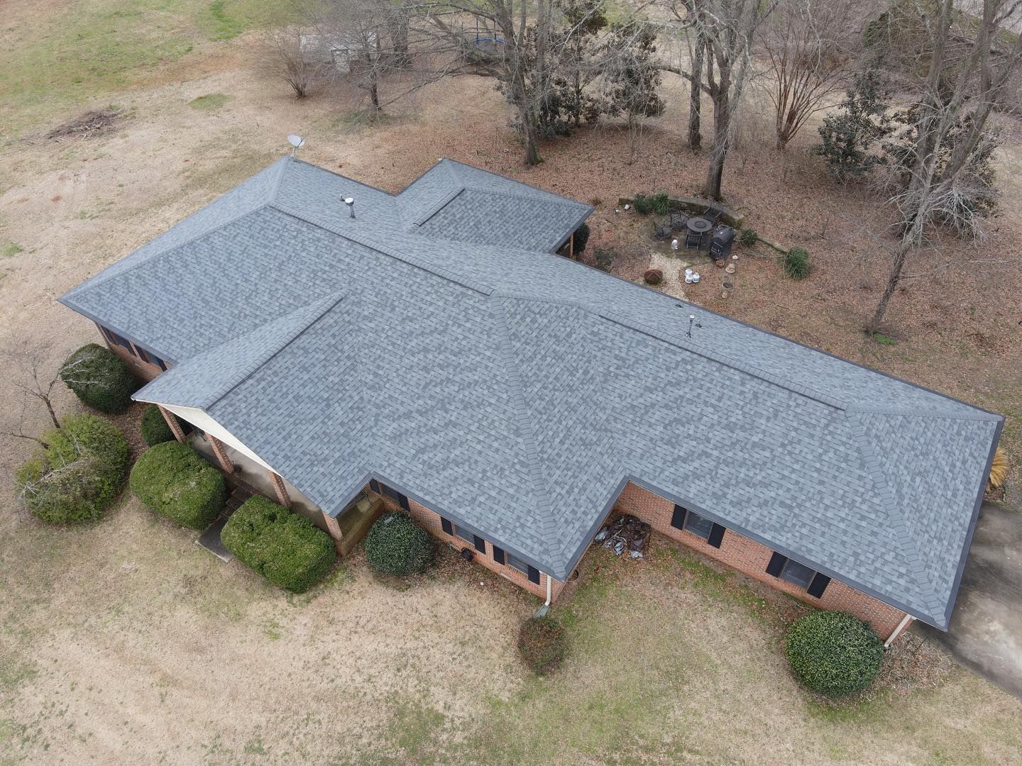 An aerial view of a house with a new roof.