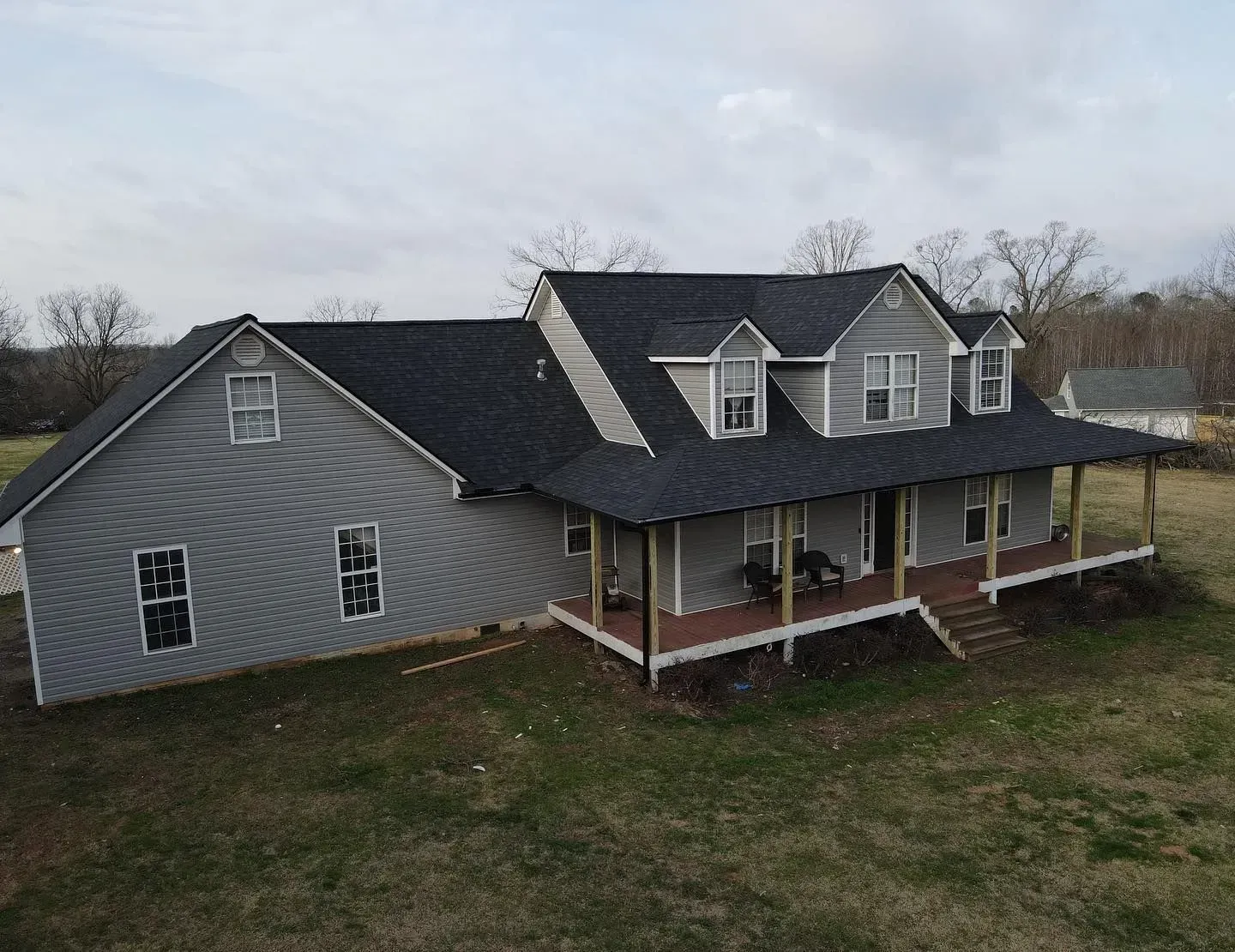An aerial view of a large house with a porch.