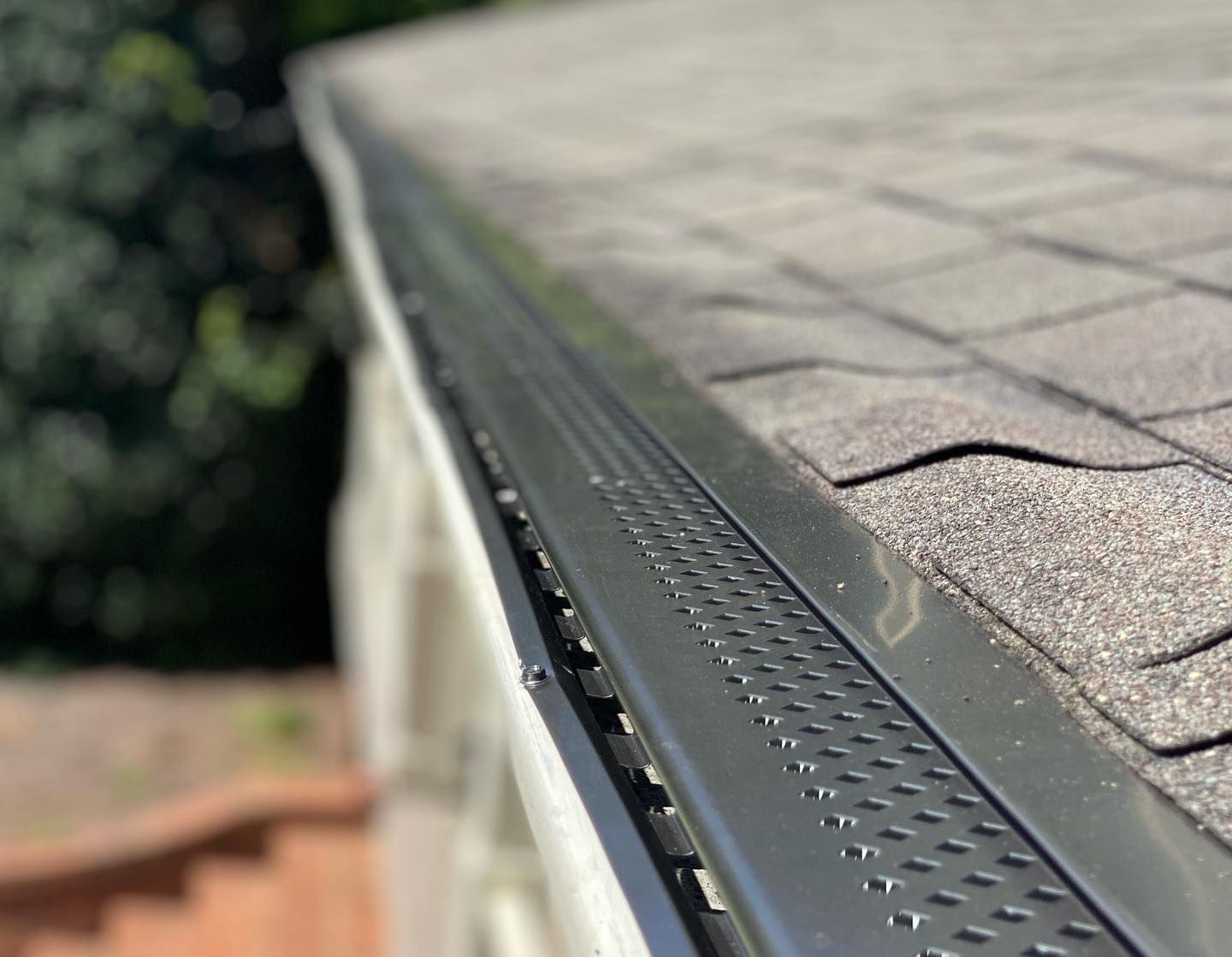 A close up of a gutter on the roof of a house.