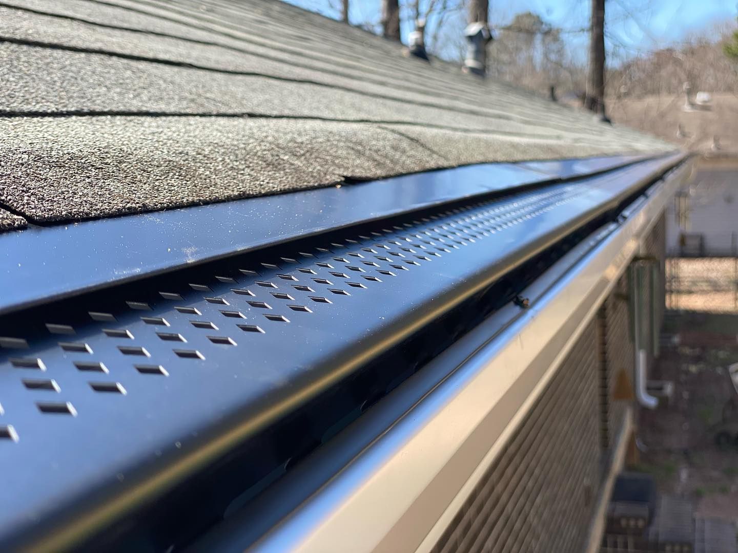 A close up of a gutter on the roof of a house