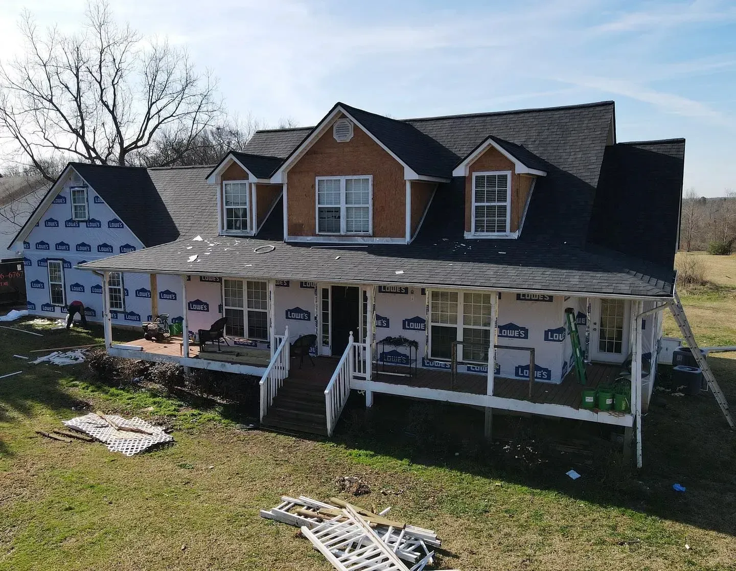 An aerial view of a house under construction with a porch.