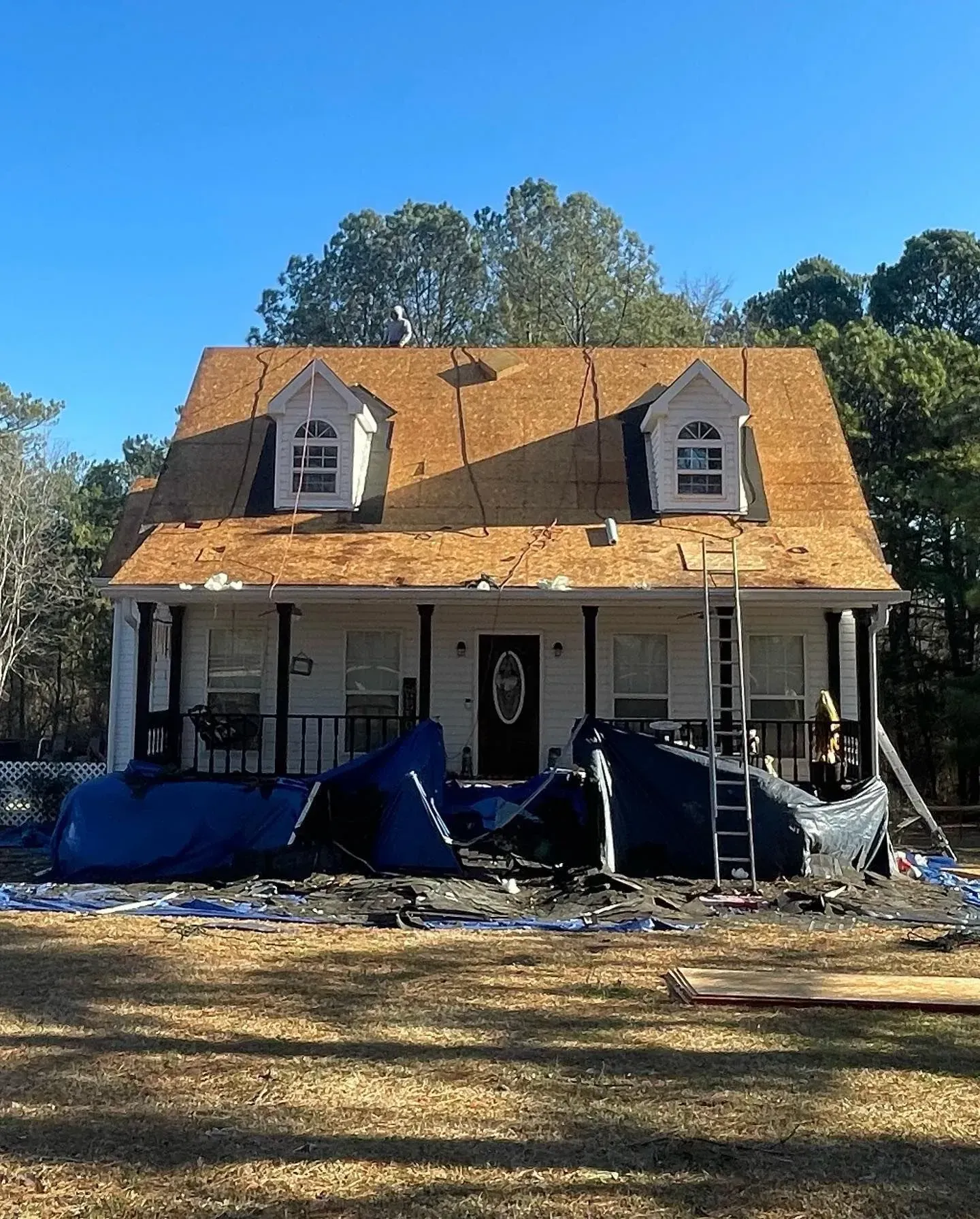 A house with a roof that is being repaired