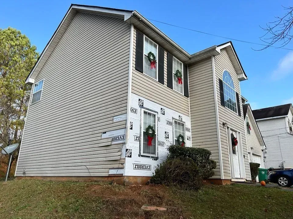 A house with a lot of windows and a wreath on the window.