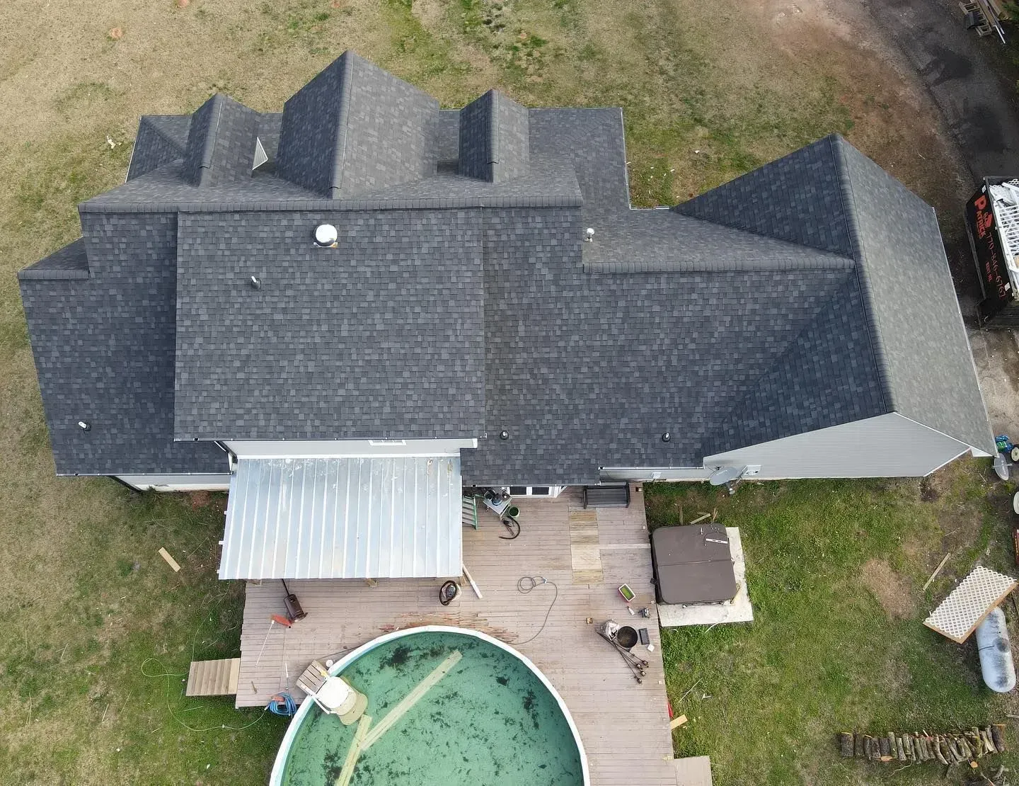 An aerial view of a house with a pool in the backyard.