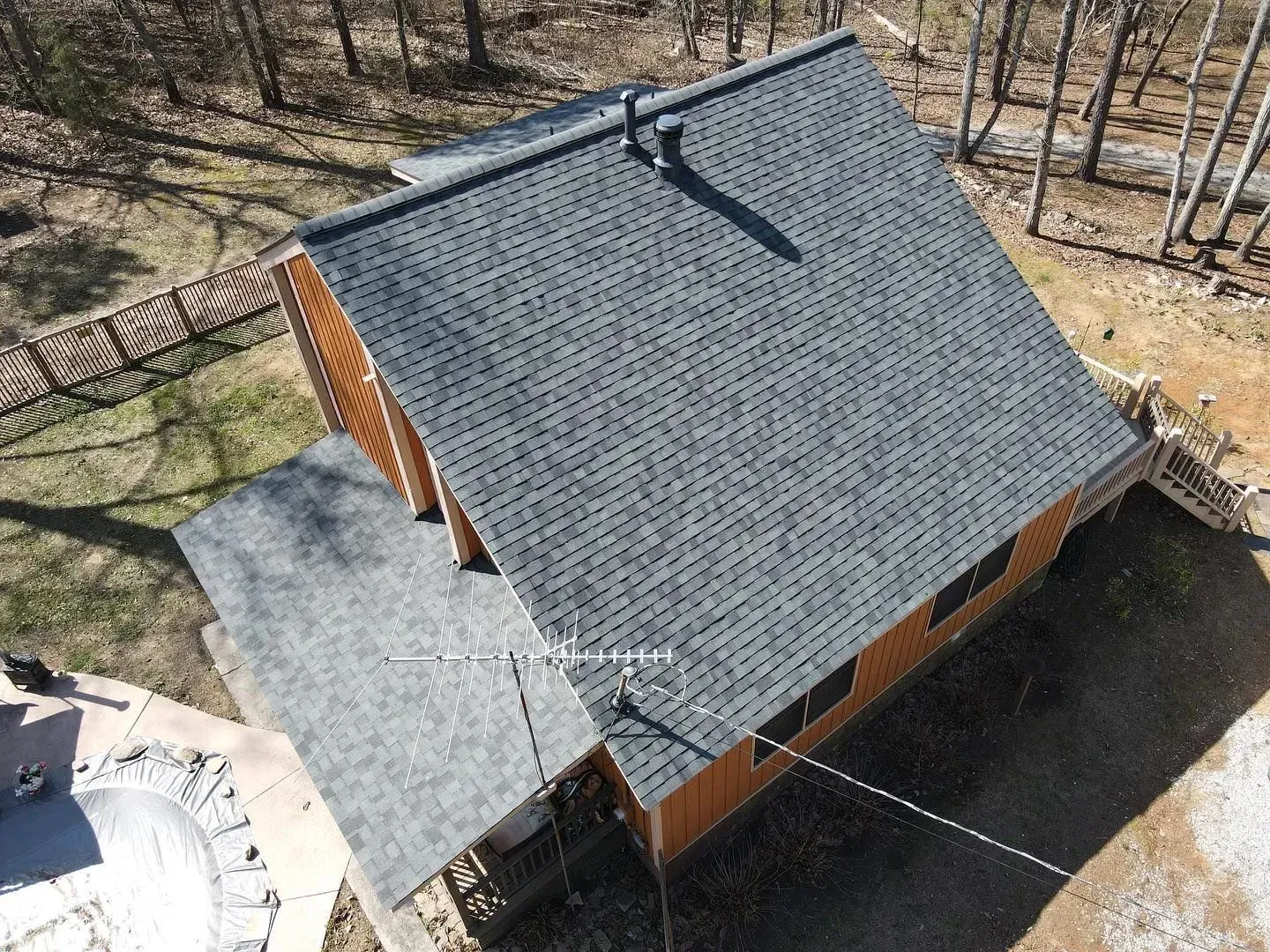 An aerial view of a house with a roof that is covered in shingles.