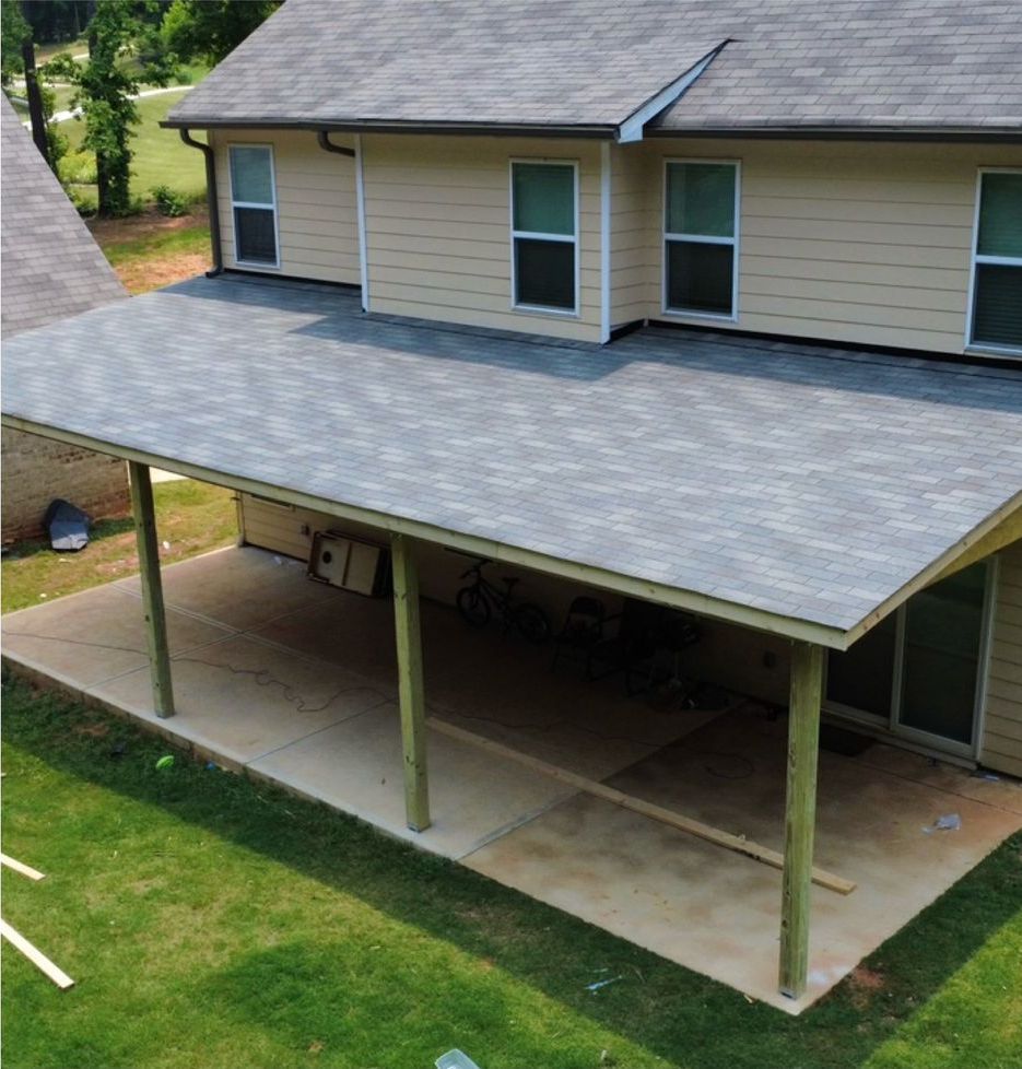 An aerial view of a house with a covered porch