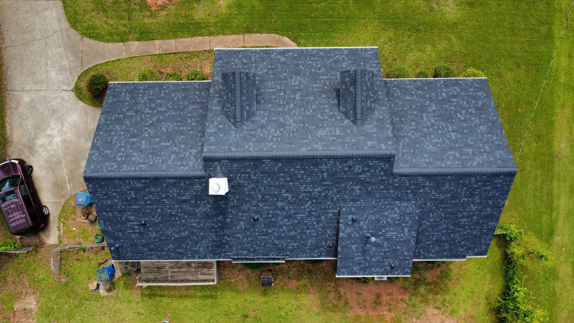 An aerial view of a house with a car parked in front of it.