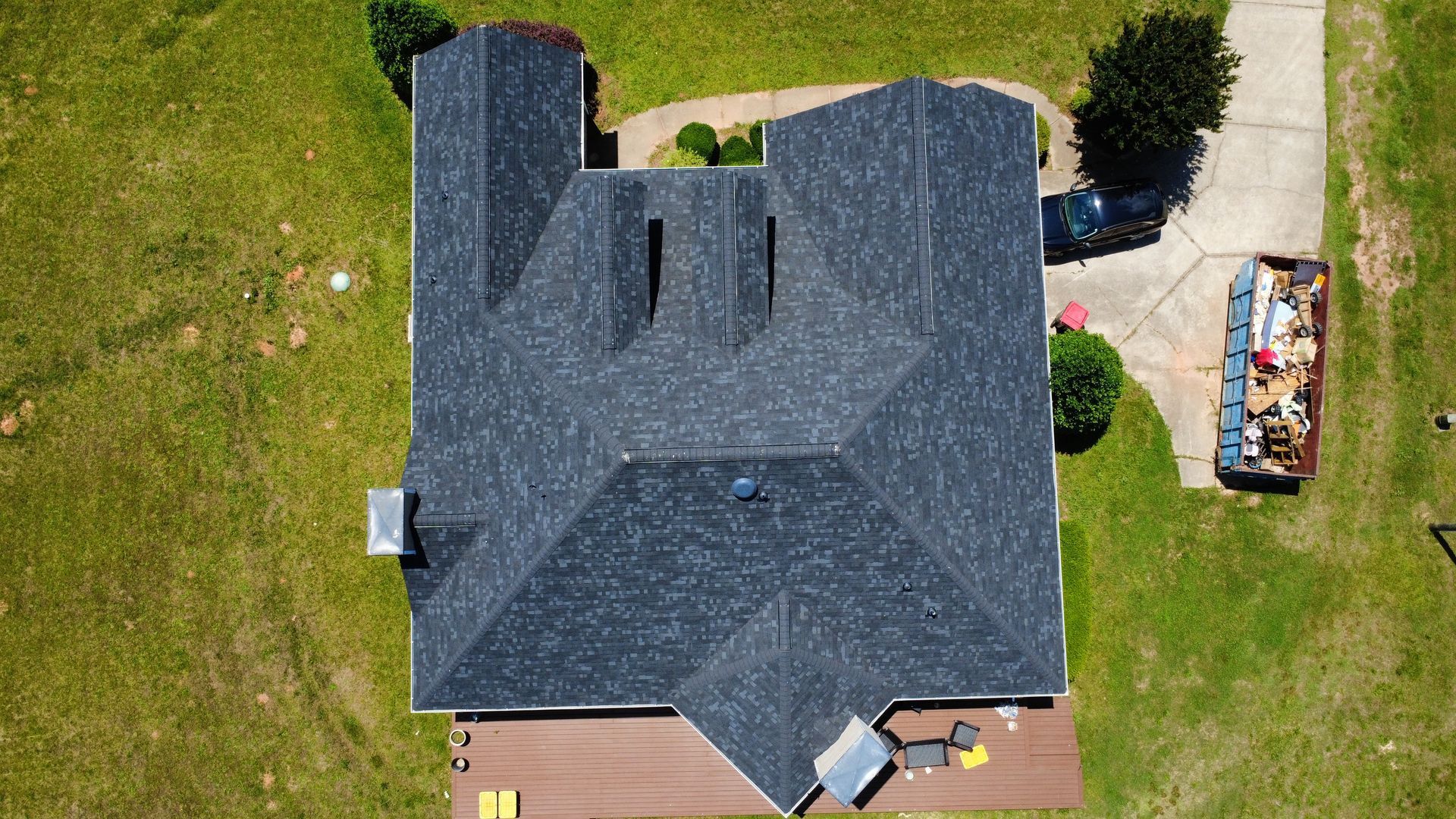 An aerial view of a house with a new roof.