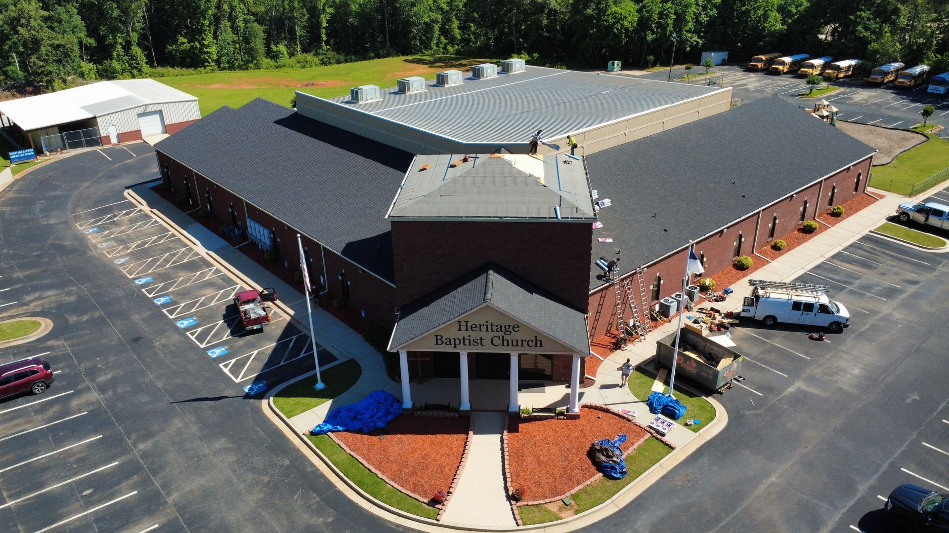 An aerial view of a large building with a parking lot in front of it