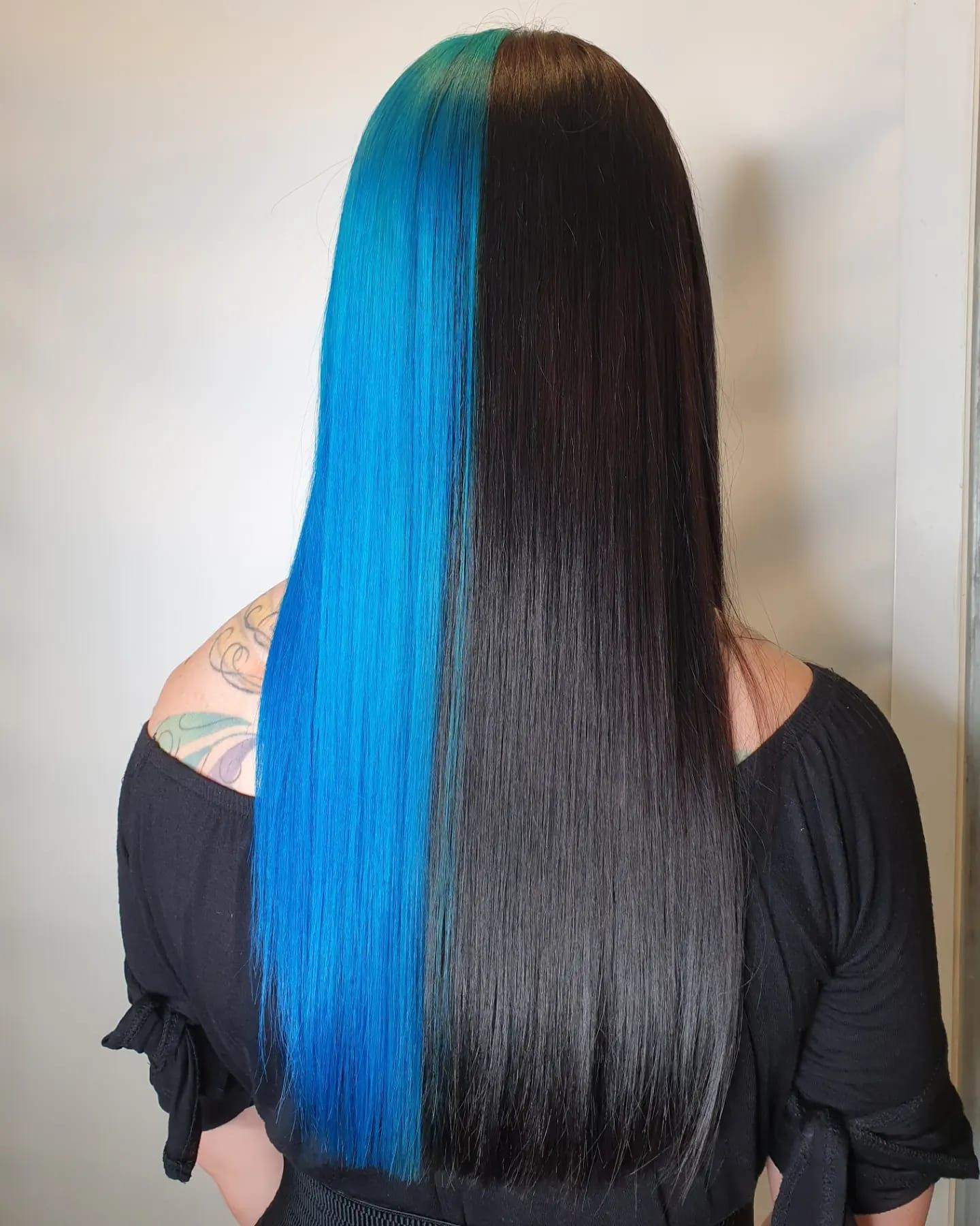 A Woman With Blue And Black Hair Is Wearing A Black Shirt — Fuse Hair & Beauty In Darwin City, NT