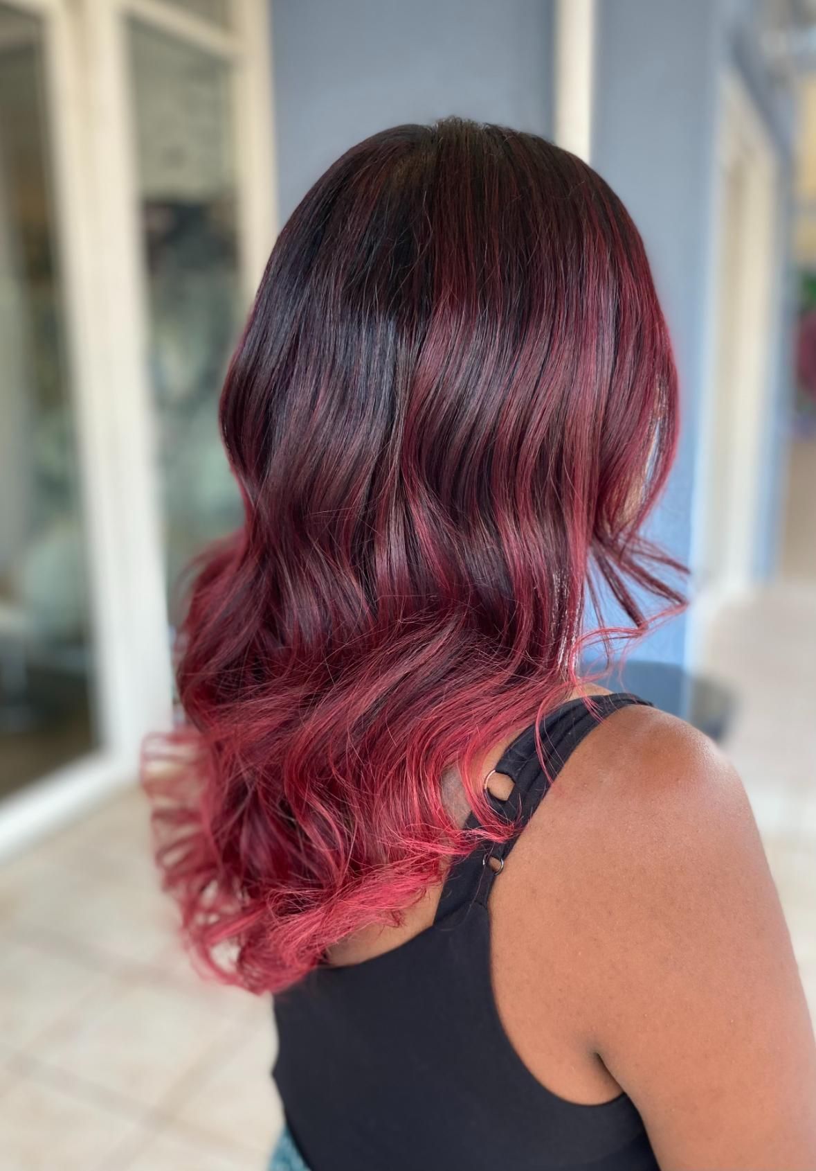 A Woman With Red Hair Is Wearing A Black Tank Top — Fuse Hair & Beauty In Darwin City, NT