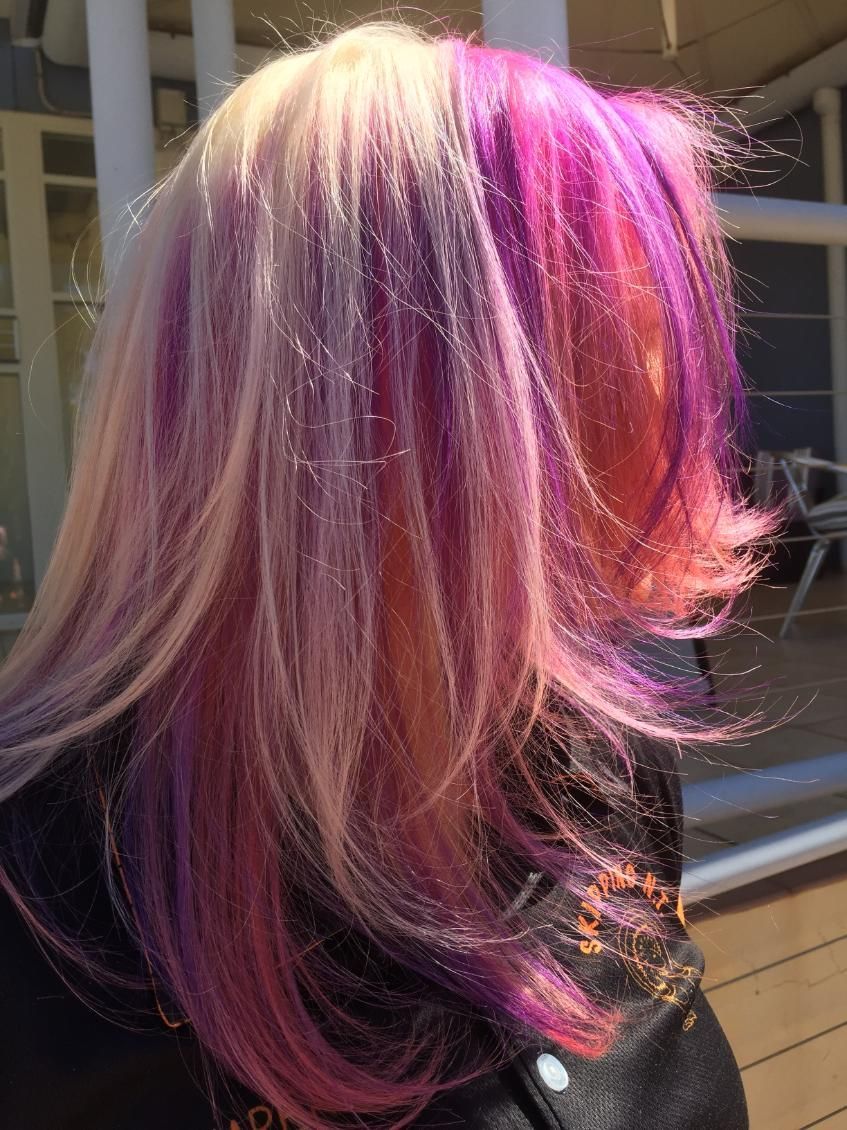 A Woman With Purple And Pink Hair Is Standing In Front Of A Window — Fuse Hair & Beauty In Darwin City, NT