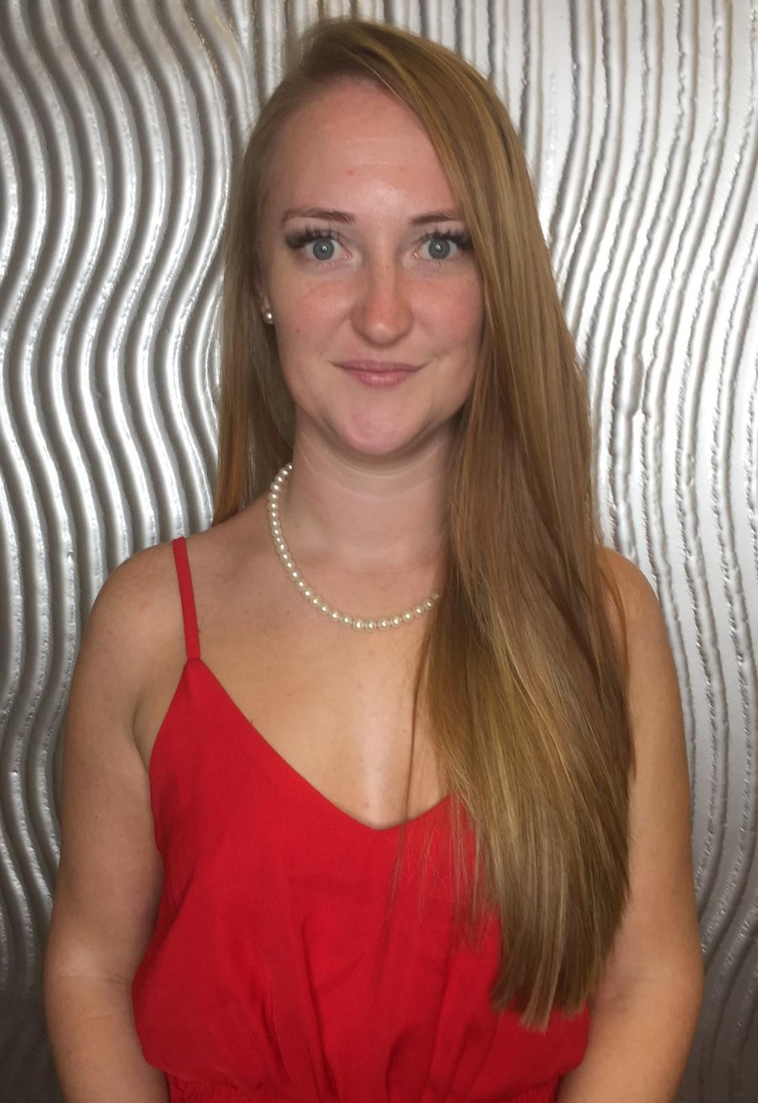 The Woman Is Wearing A Red Dress And A Pearl Necklace — Fuse Hair & Beauty In Darwin City, NT