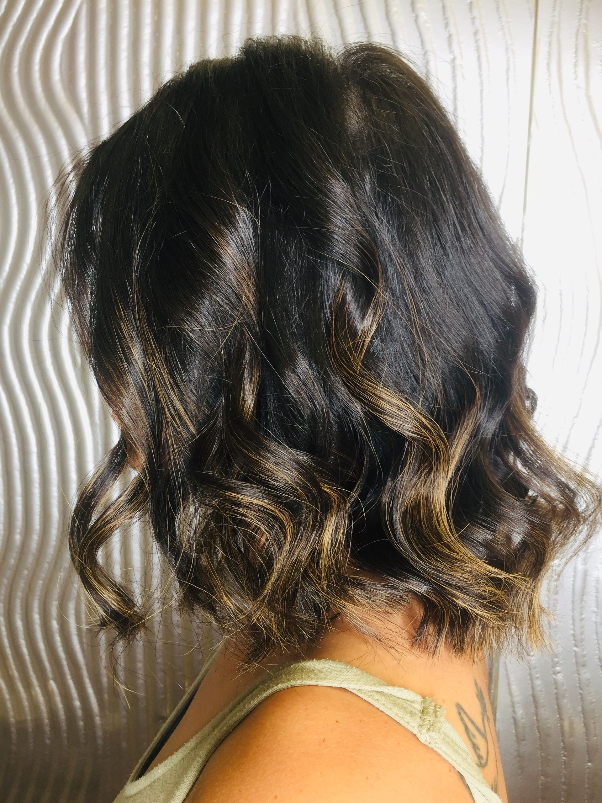 A Woman With Short Curly Hair Is Wearing A Green Tank Top — Fuse Hair & Beauty In Darwin City, NT