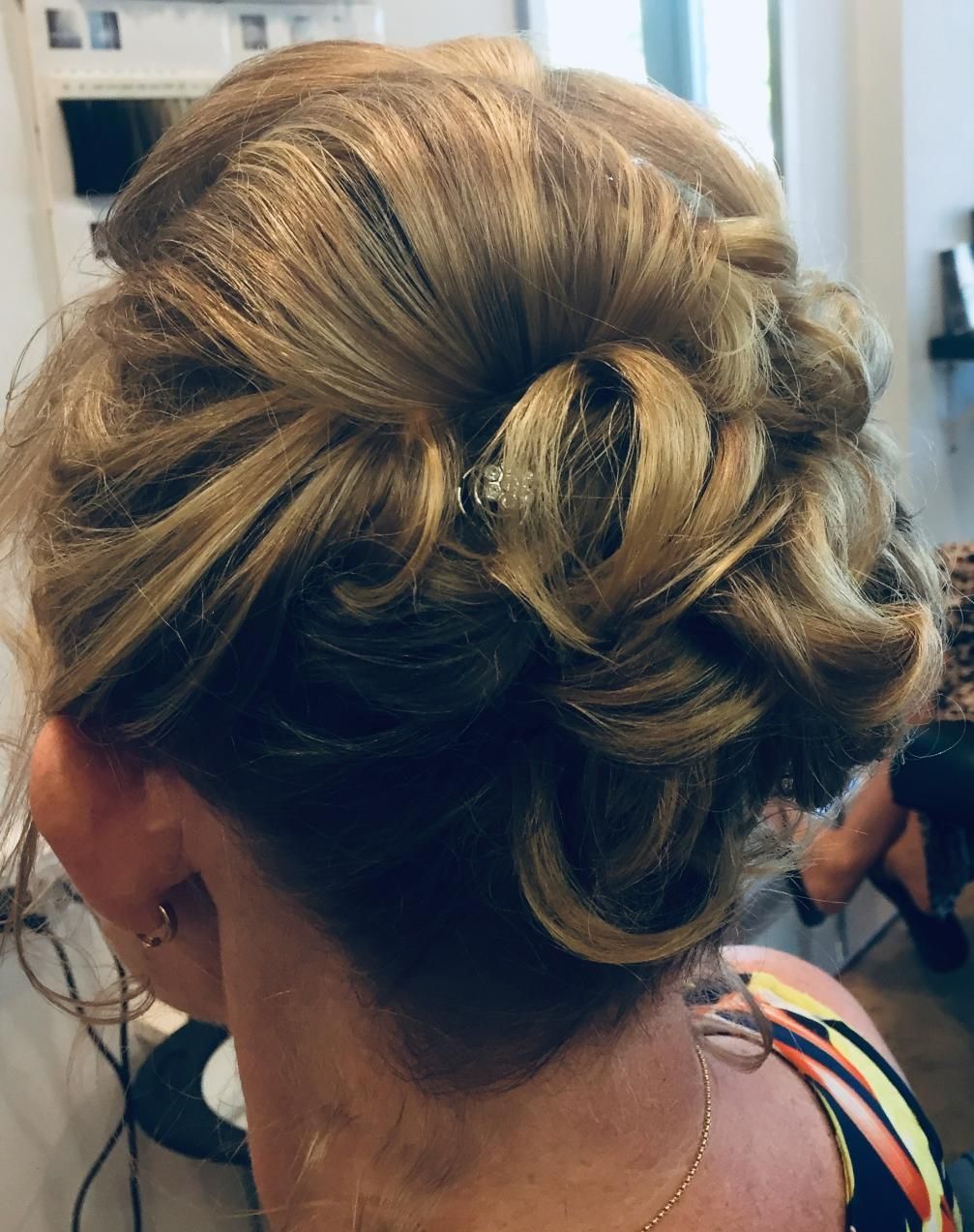 A Woman Is Getting Her Hair Done In A Bun — Fuse Hair & Beauty In Darwin City, NT