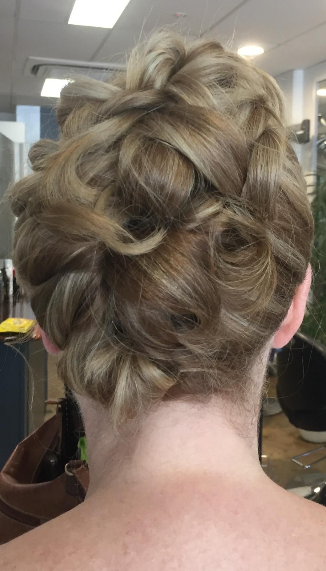 The Back Of A Woman 's Head With Her Hair In A Braided Bun — Fuse Hair & Beauty In Darwin City, NT