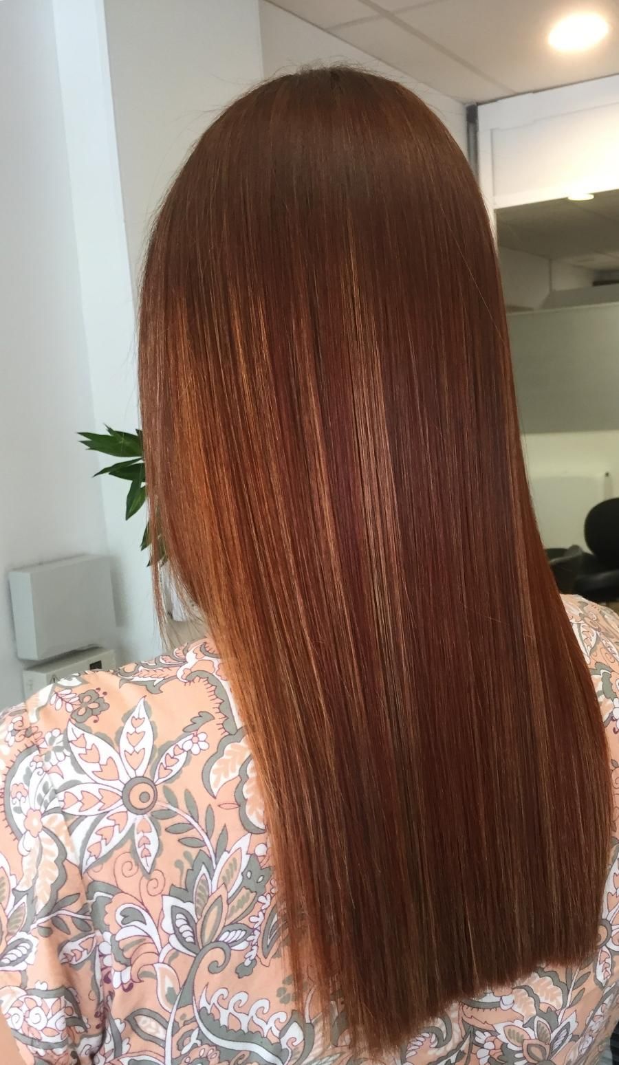 A Woman With Long Brown Hair Is Wearing A Floral Shirt — Fuse Hair & Beauty In Darwin City, NT