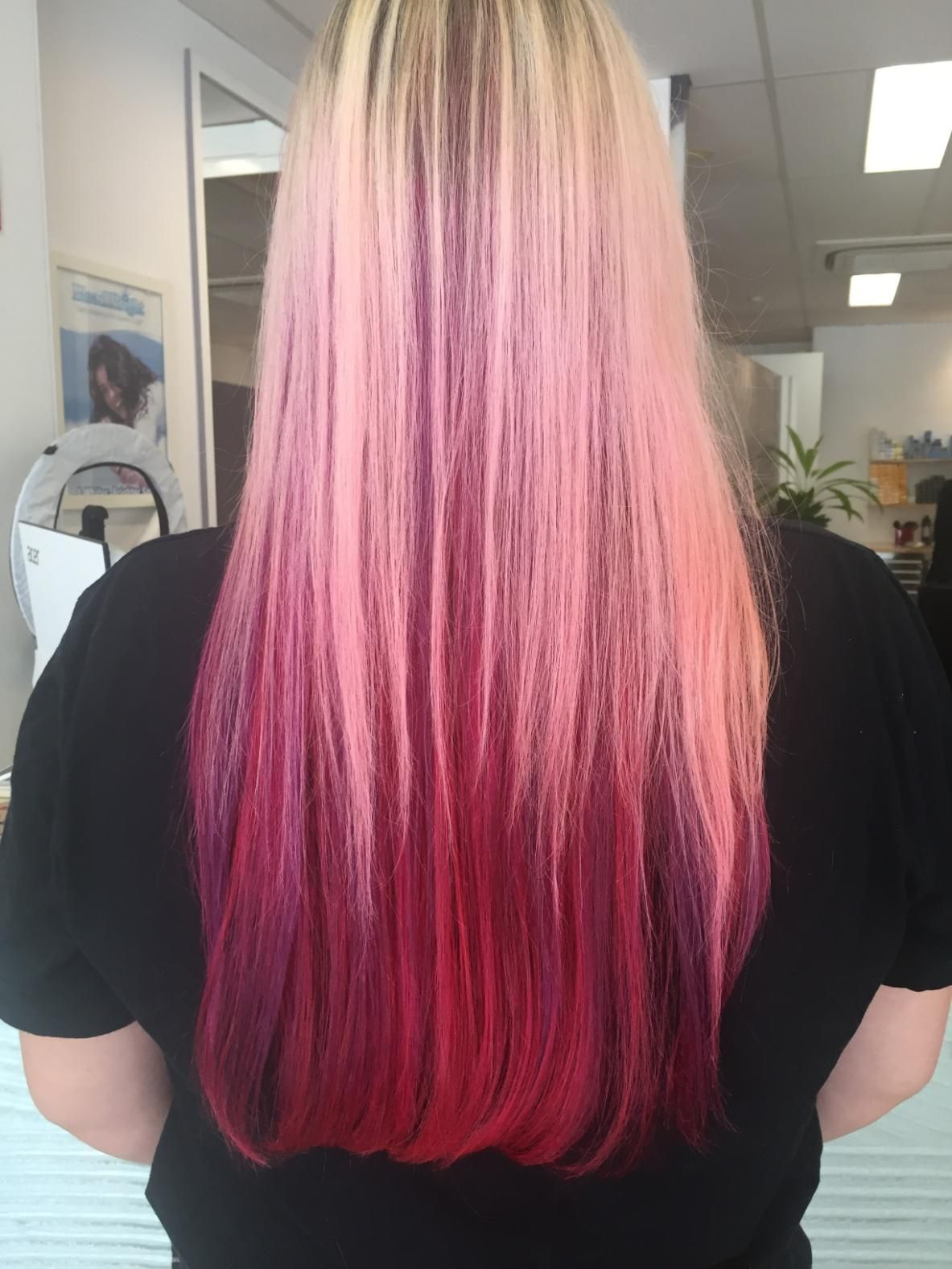 A Woman With Pink And Red Hair Is Wearing A Black Shirt — Fuse Hair & Beauty In Darwin City, NT