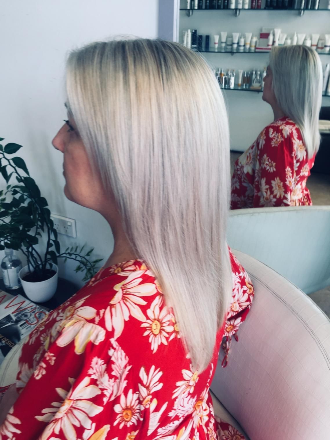 A Woman With Blonde Hair Is Sitting In Front Of A Mirror — Fuse Hair & Beauty In Darwin City, NT