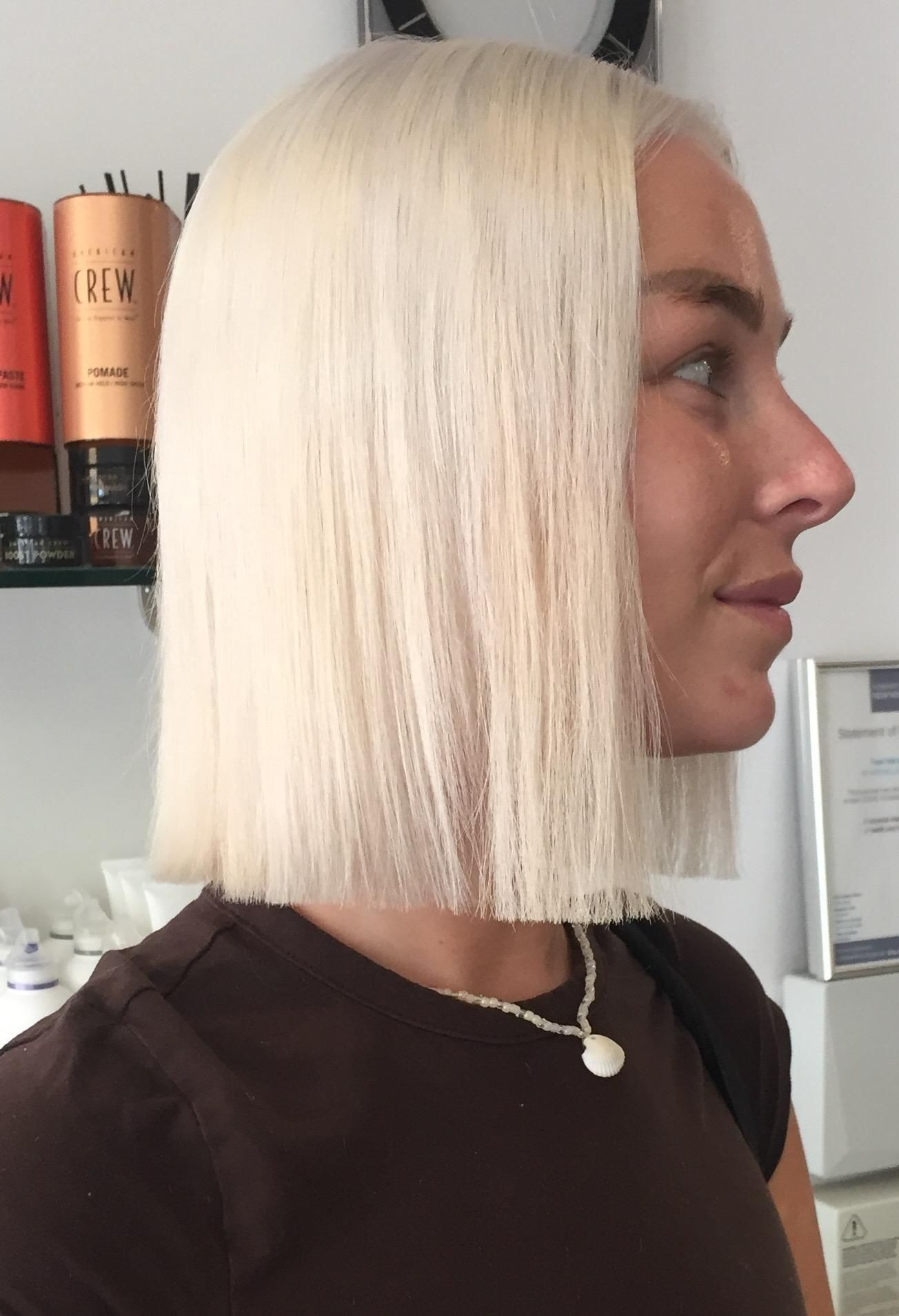 A Woman With Blonde Hair Is Wearing A Brown Shirt And A Necklace — Fuse Hair & Beauty In Darwin City, NT