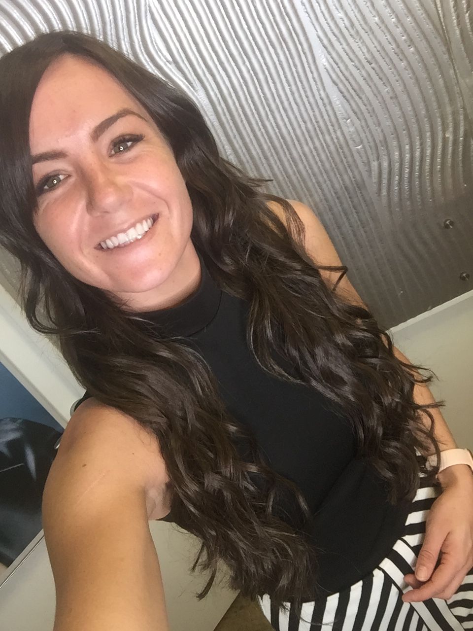 A Woman With Long Hair Is Taking A Selfie And Smiling — Fuse Hair & Beauty In Darwin City, NT