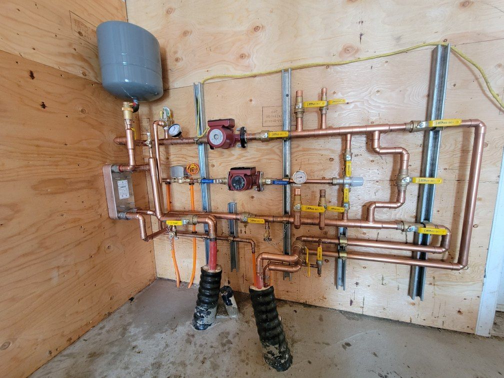 A room with a lot of pipes hanging on the wall.