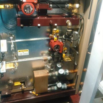 The inside of a machine with a caution sign on it