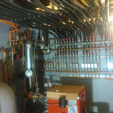 A room with a lot of pipes hanging from the ceiling