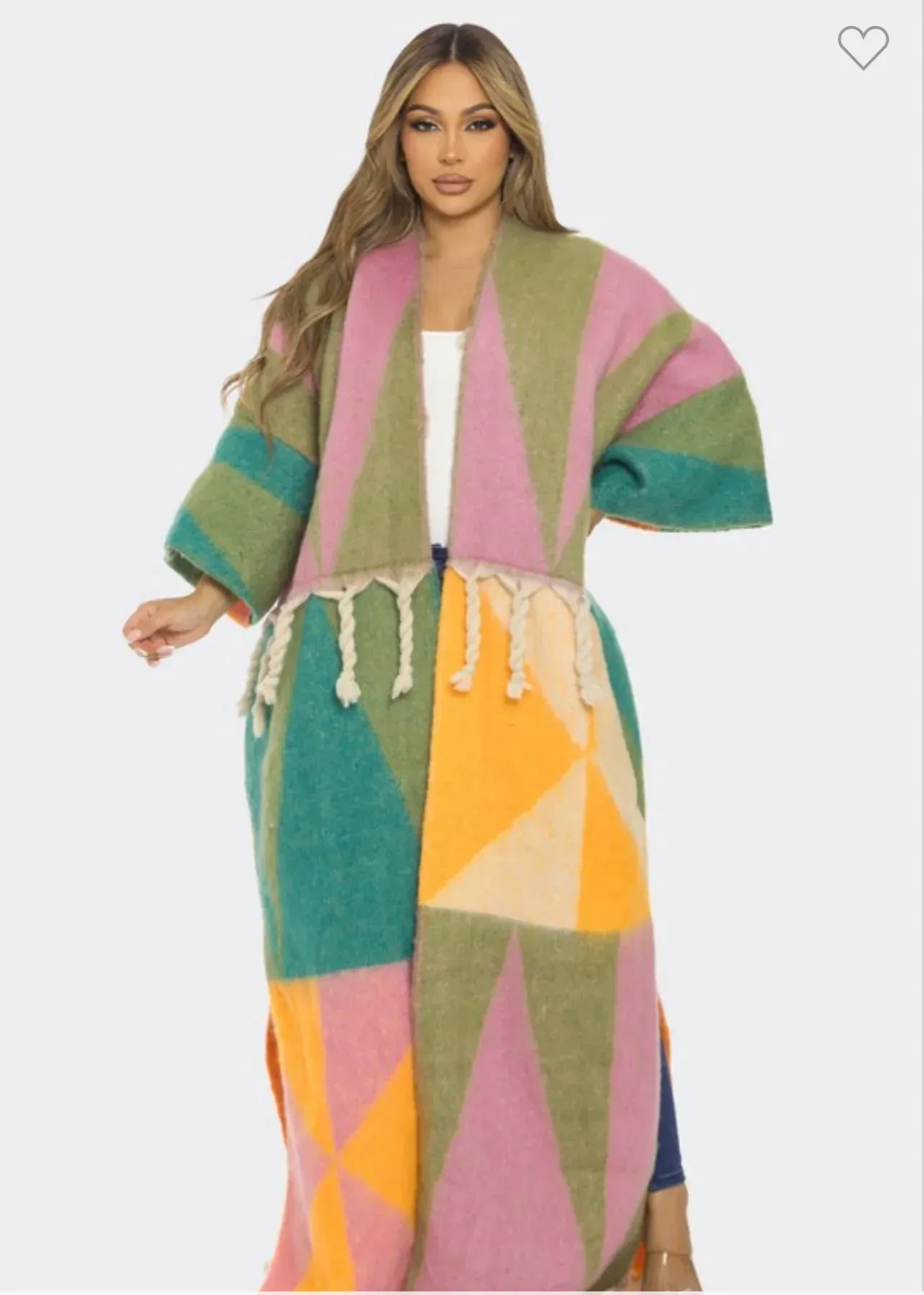 A woman is wearing a long colorful coat with fringe