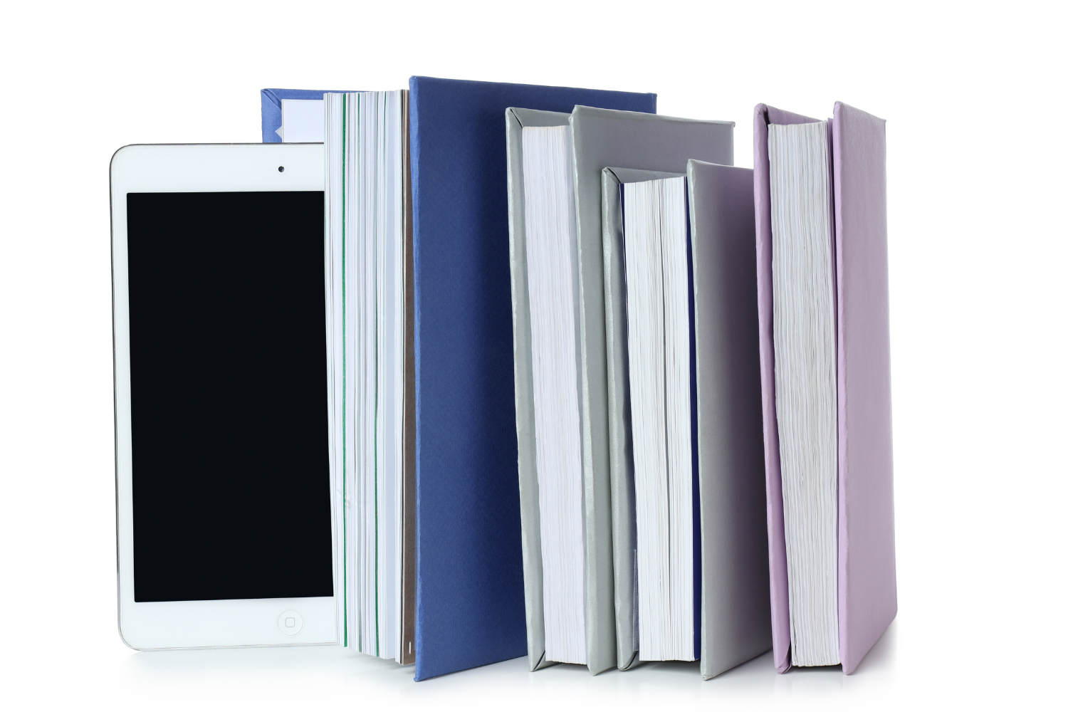 A stack of books and a tablet on a white background.