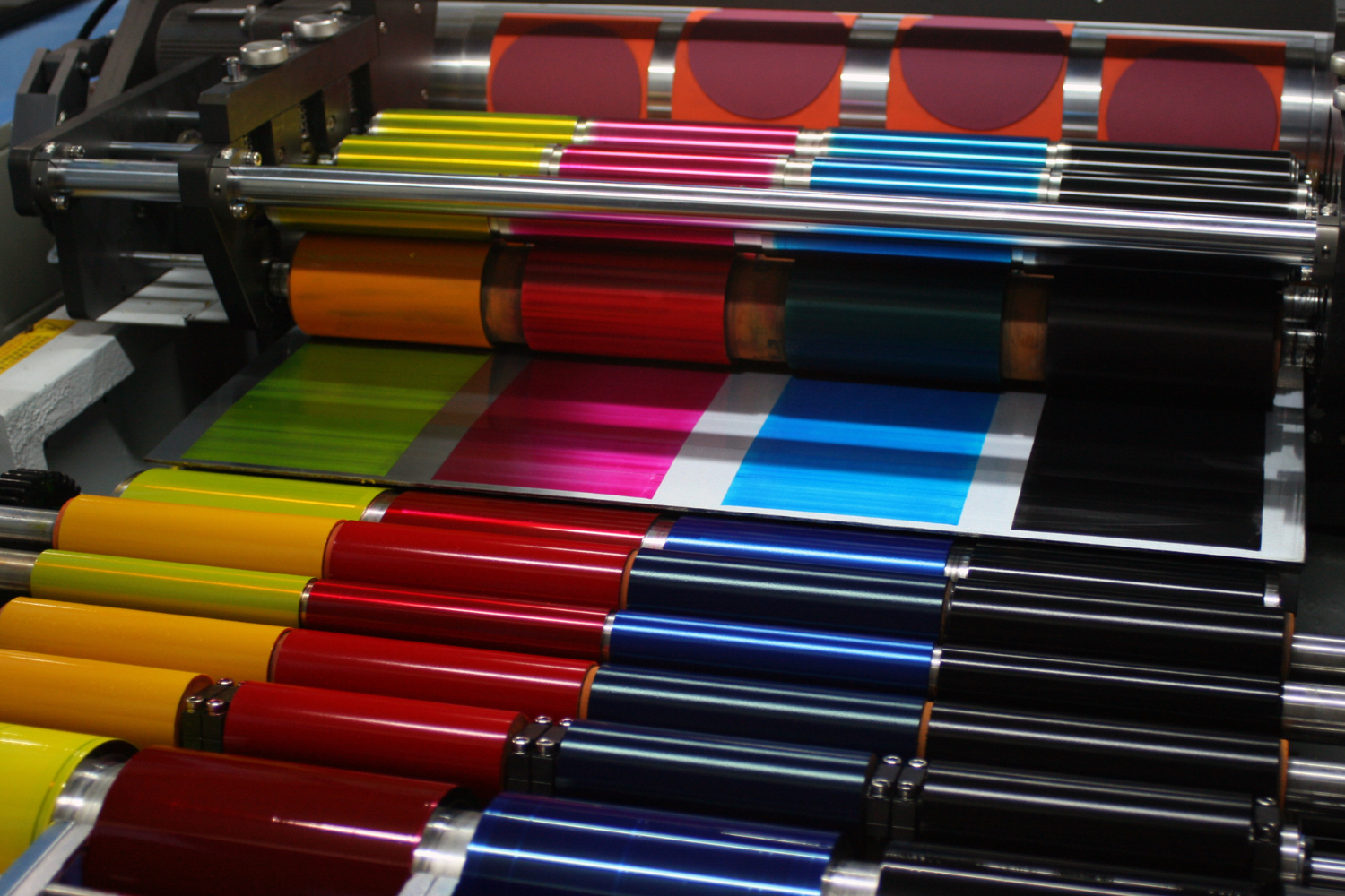 A bunch of colorful papers are being printed on a machine