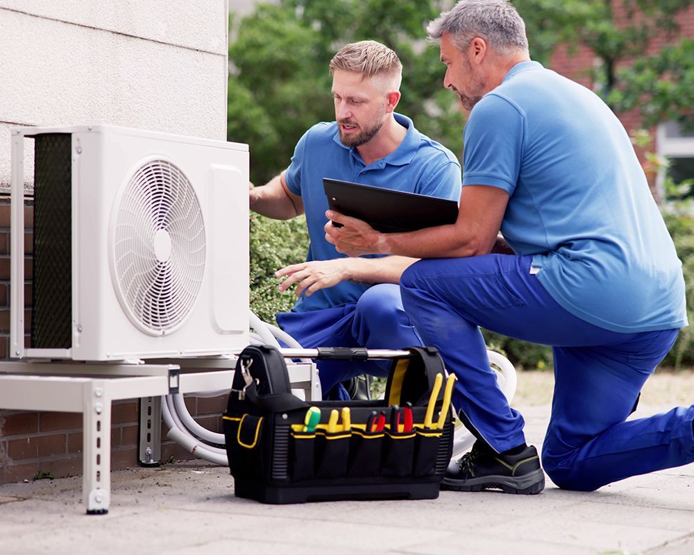 Two Men Working On Air Conditioner