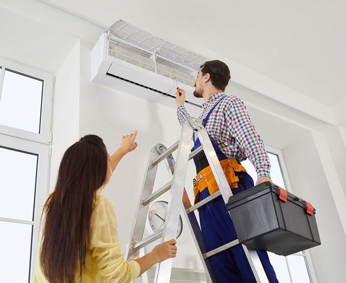 Expert Checking The Air Conditioner