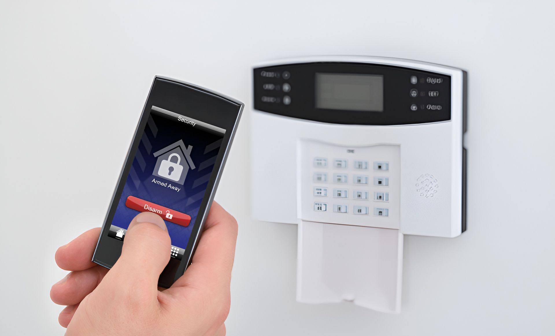 A Person is Holding a Cell Phone in Front of a Security System — Adept Security In Thirroul, NSW