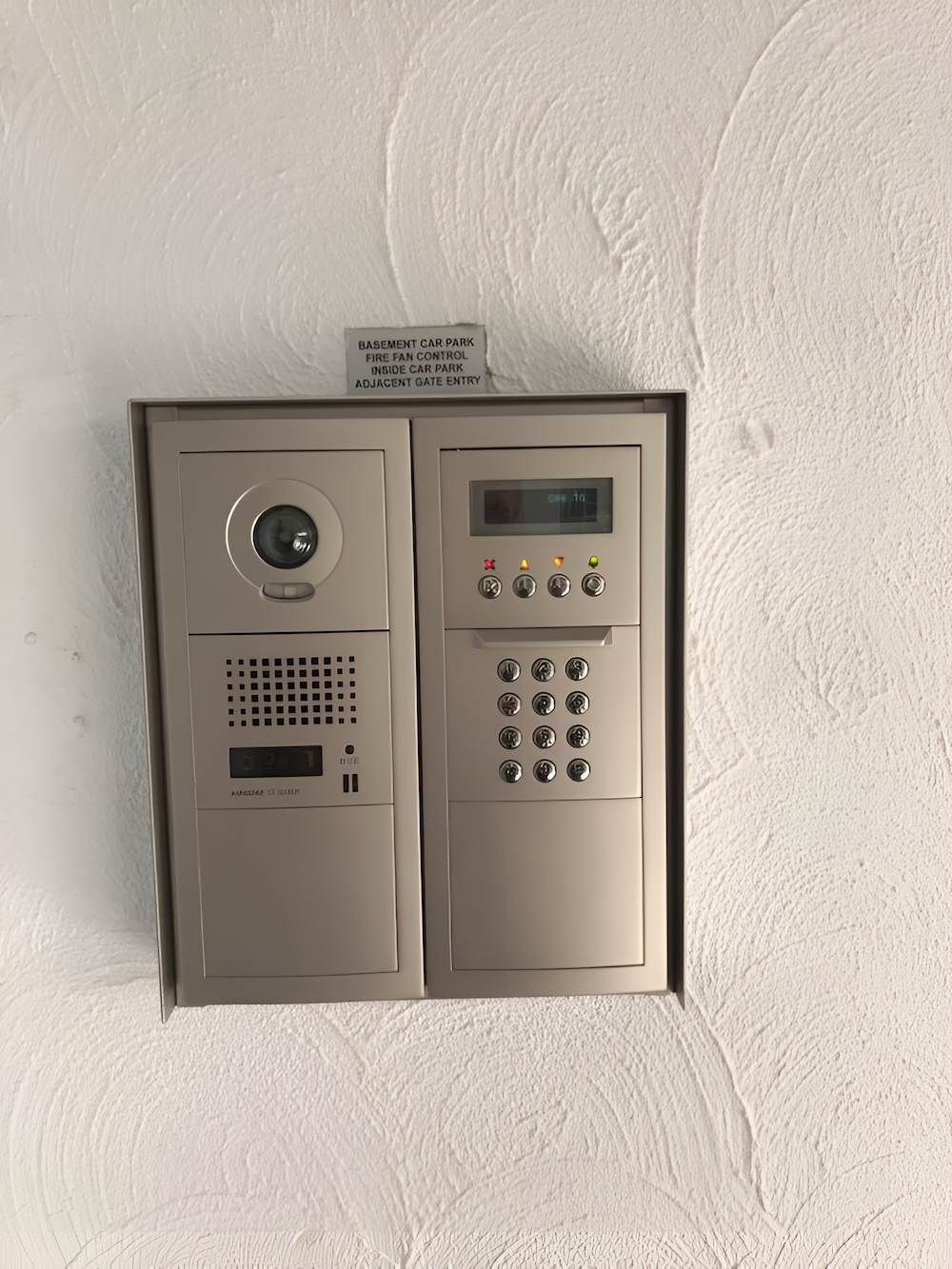 A White Wall With Two Phones and a Keypad on It — Adept Security In Oak Flats, NSW