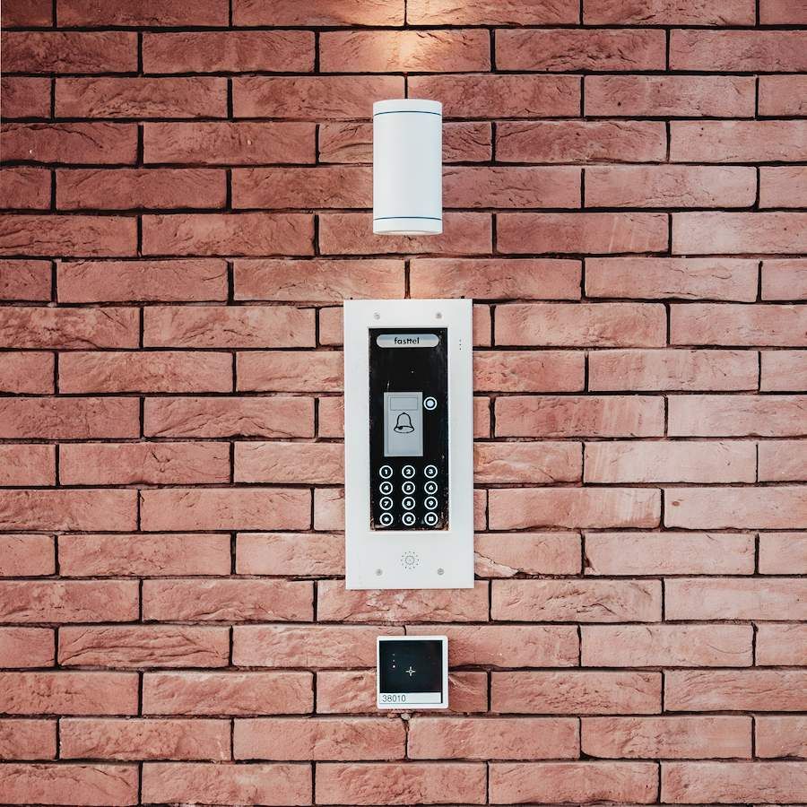 A Brick Wall With a Keypad and a Light on It — Adept Security In Shellharbour, NSW