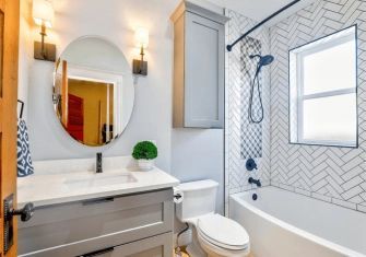A bathroom with a toilet , sink , and bathtub.
