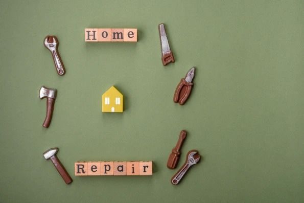 A circle of wooden blocks with the word home and repair written on them.