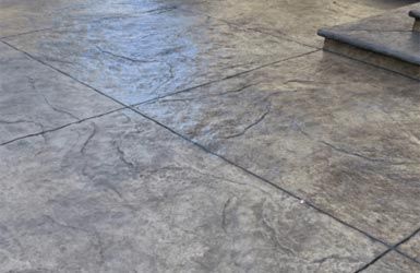 A close up of a concrete floor with stairs in the background.