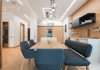 A dining room with a table and chairs and a bench.
