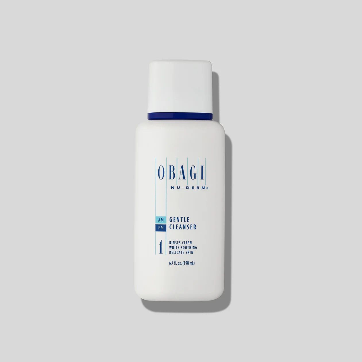 A white bottle of Obagi skincare product is sitting on a white surface.