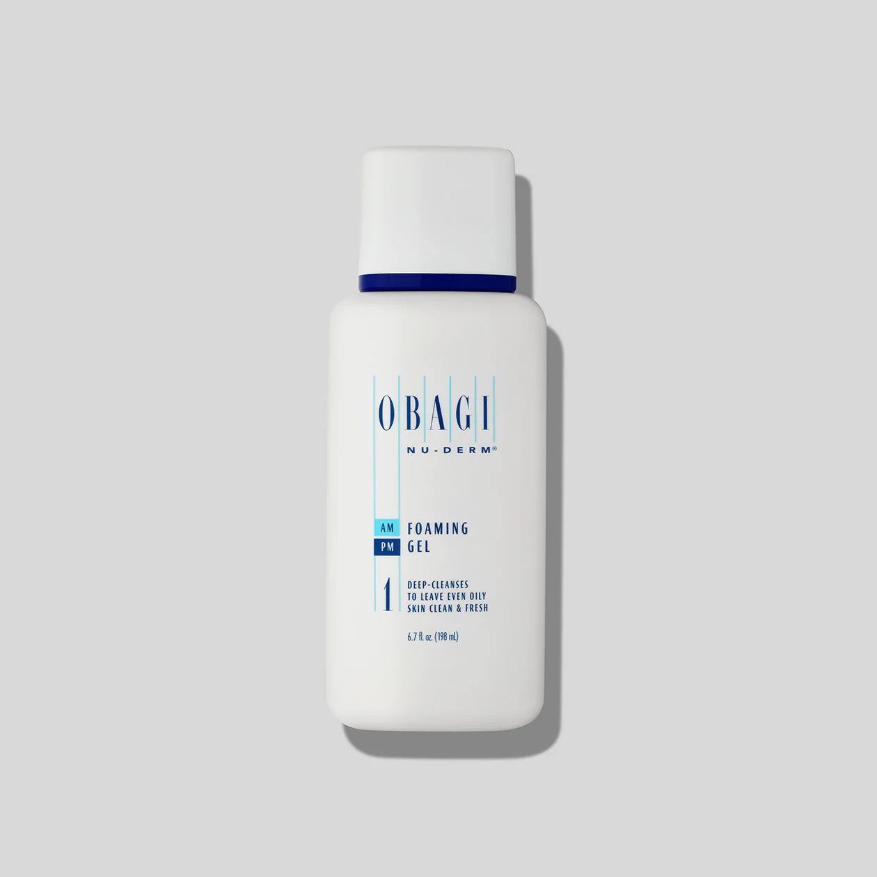 A white bottle of Obagi skincare product is sitting on a white surface.