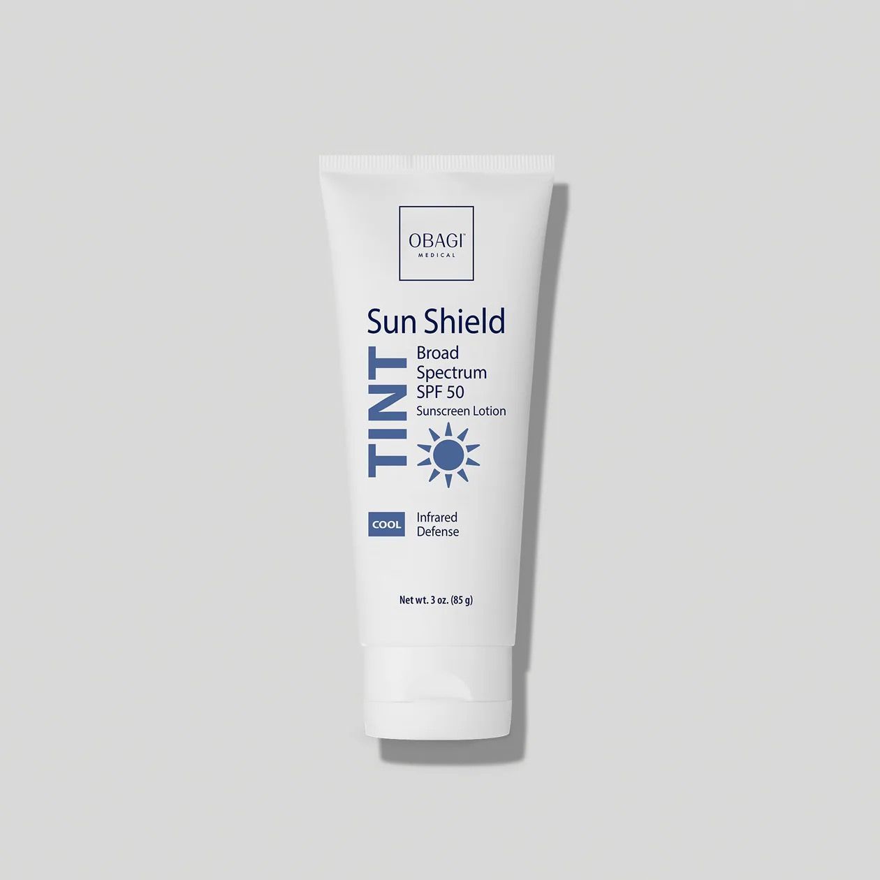 A tube of sun shield tint is sitting on a white surface.