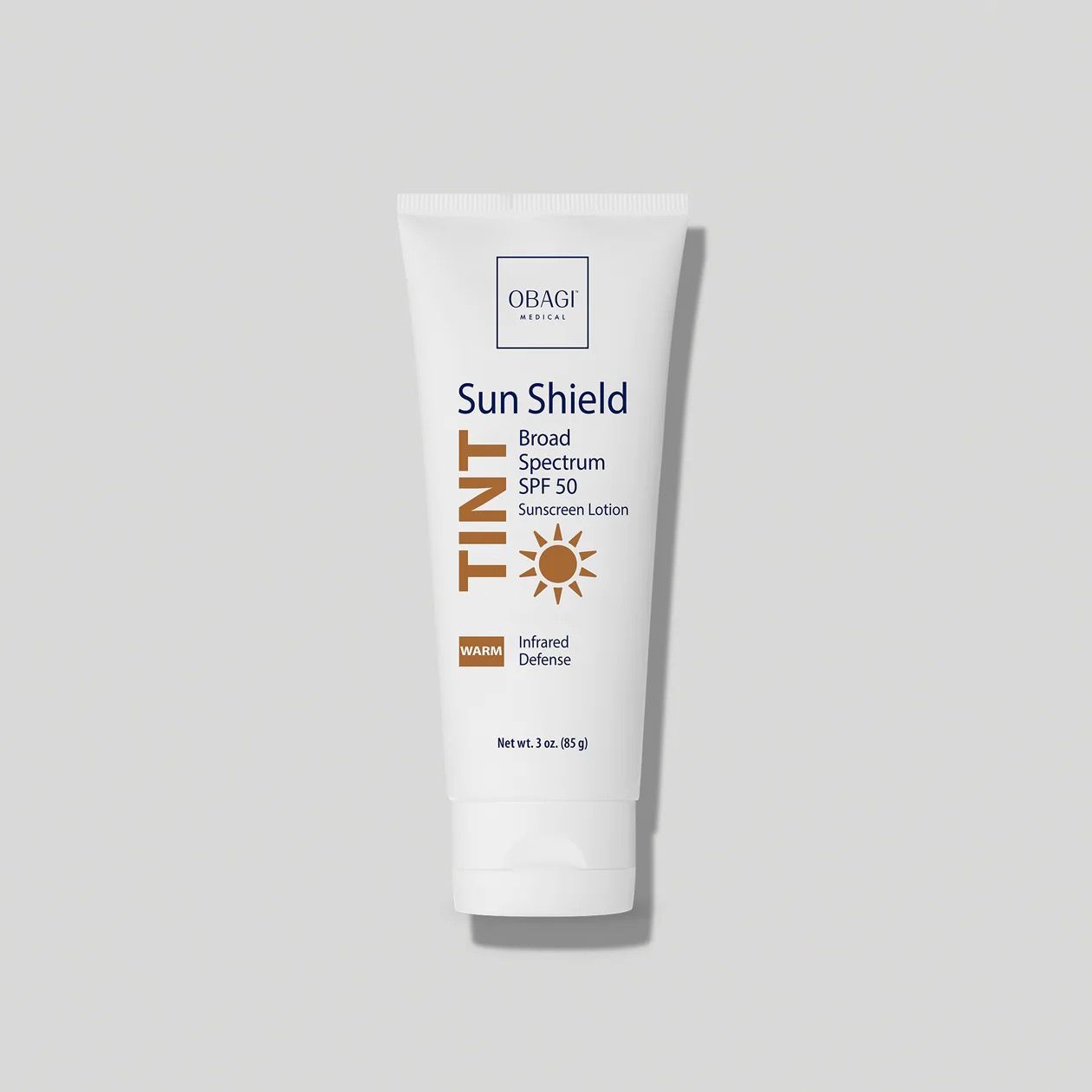 A tube of sun shield tint is sitting on a white surface.