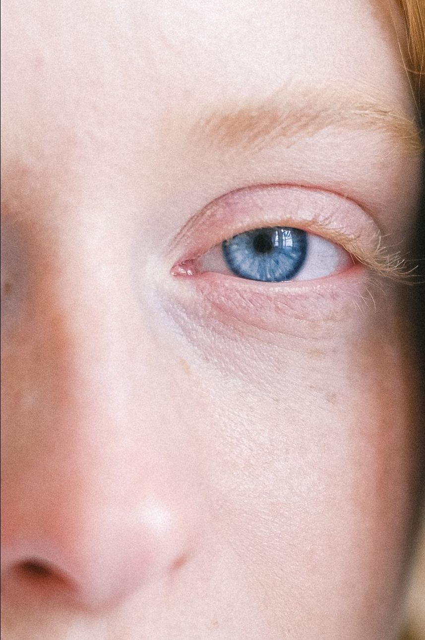 A close up of a child 's blue eye and nose