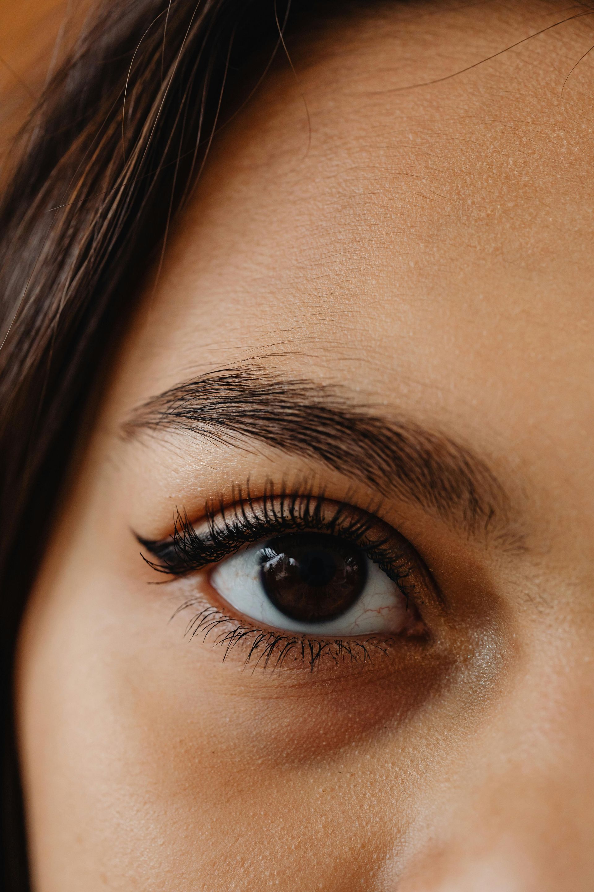 A close up of a woman 's eye with makeup on it.