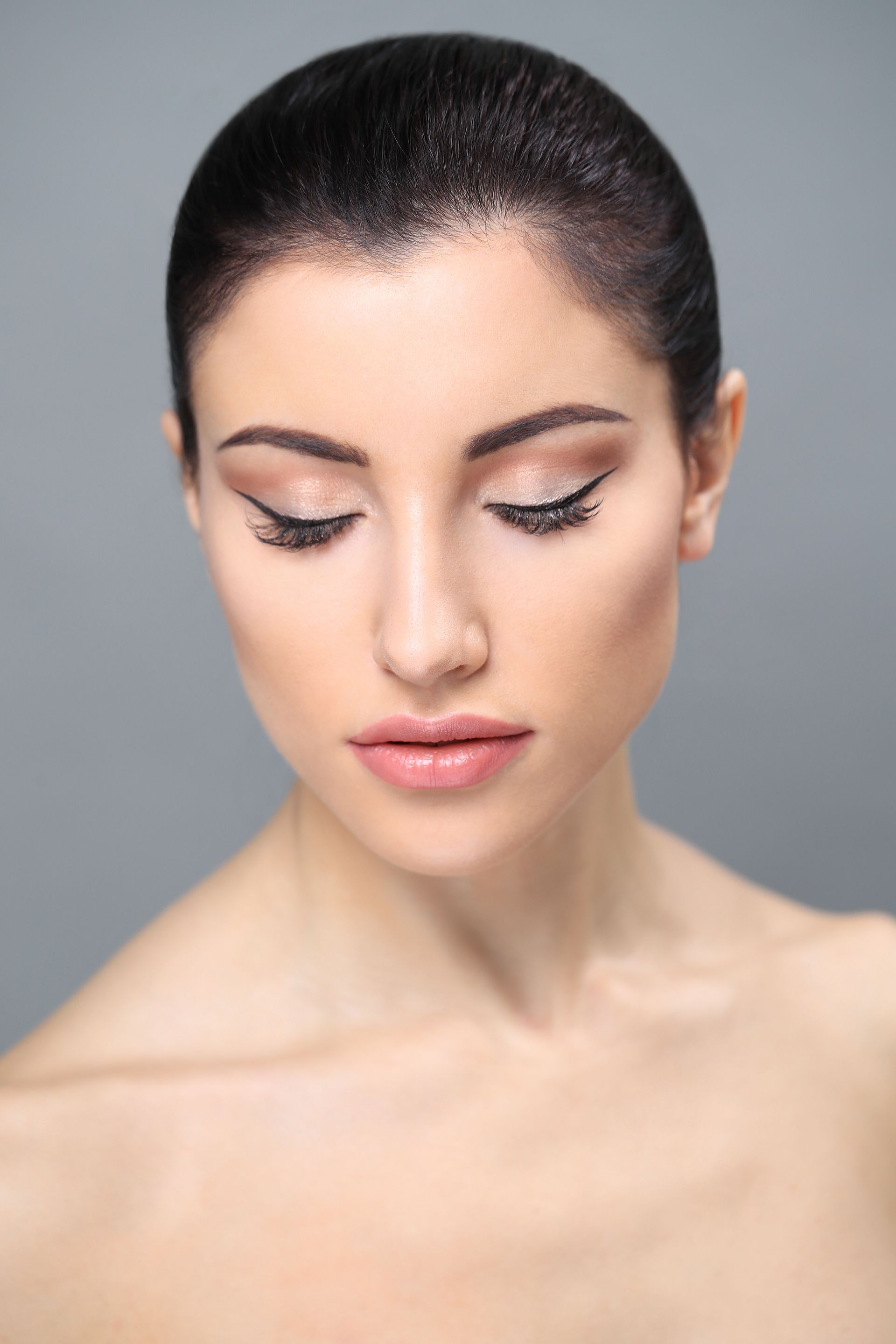 A close up of a woman 's face with her eyes closed.