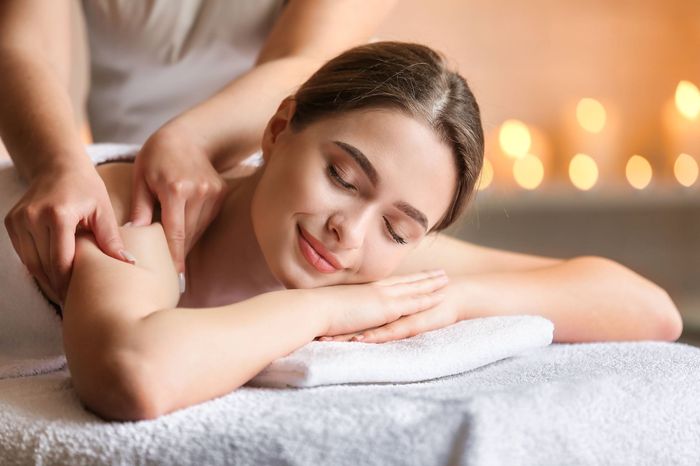 a woman is getting a massage at a spa