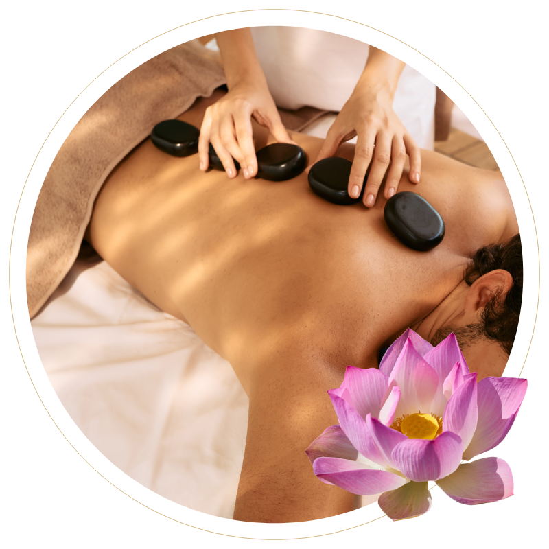 a man is getting a massage with hot rocks and a lotus flower in the background